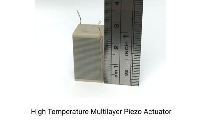 A beige high temperature multilayer piezoelectric actuator next to a ruler on a white surface. The ruler shows that the actuator is 2.4 cm tall. Underneath this image is text that says, "High Temperature Multilayer Piezoelectric Actuator."